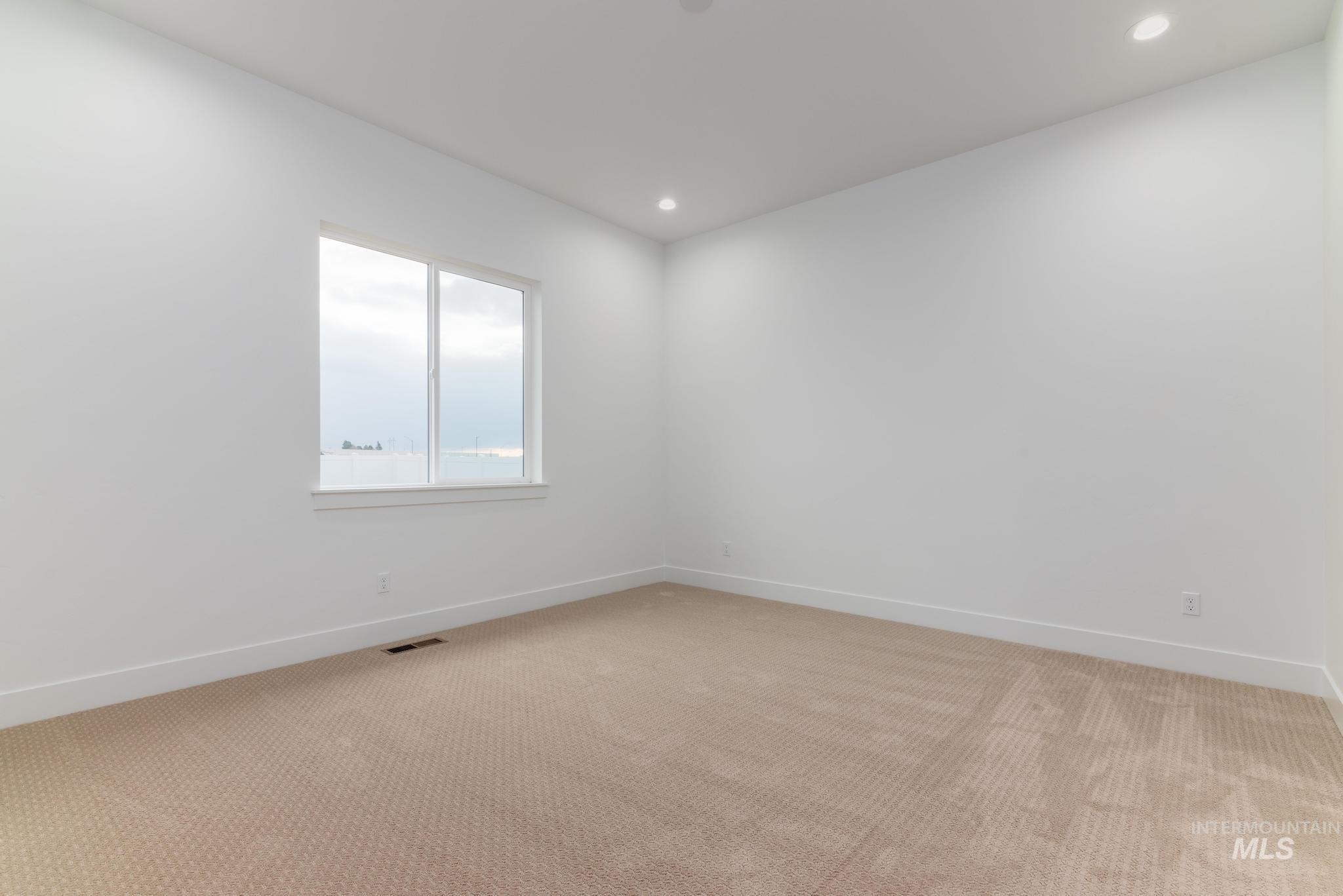 15142 Steel Cloud Avenue Caldwell, ID 83607 - Photo 17 of 34 Empty room with light carpet and recessed lighting