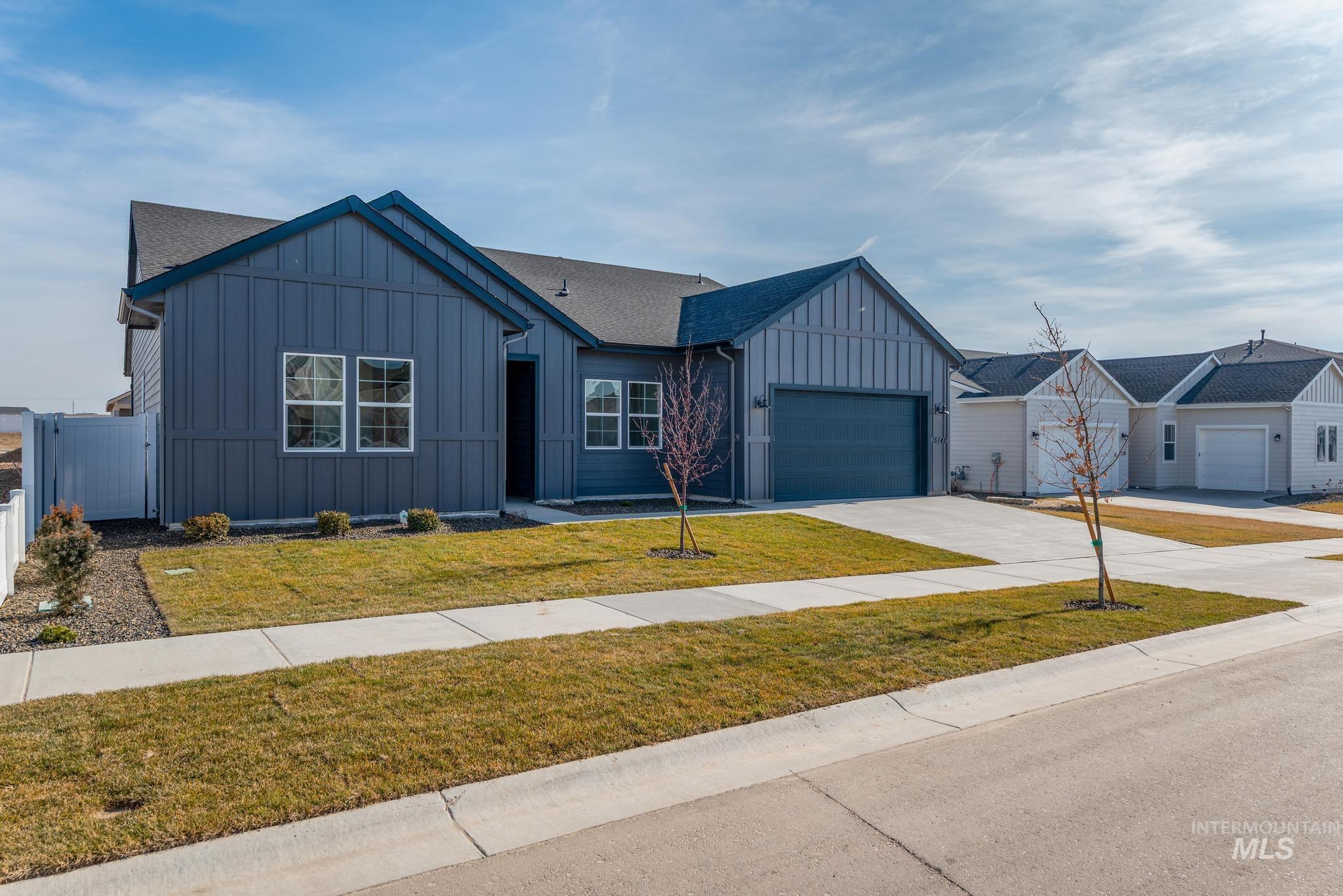 15142 Steel Cloud Avenue Caldwell, ID 83607 - Photo 2 of 44 Modern inspired farmhouse with board and batten siding, concrete driveway, a front yard, a garage, and roof with shingles