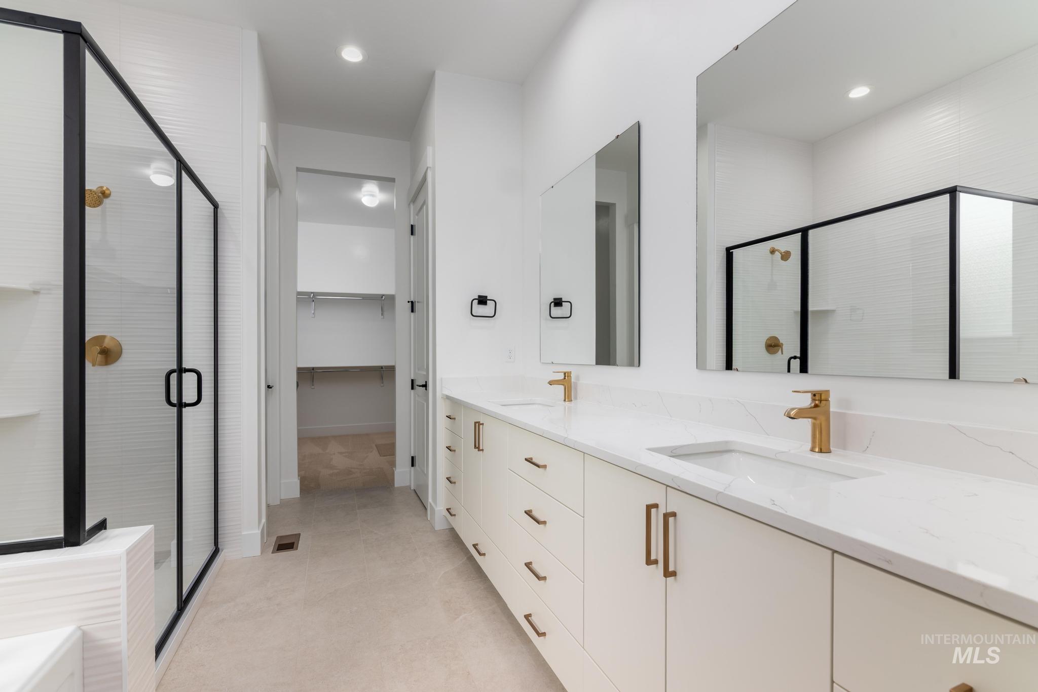 15142 Steel Cloud Avenue Caldwell, ID 83607 - Photo 20 of 34 Bathroom featuring double vanity, a stall shower, a walk in closet, and recessed lighting