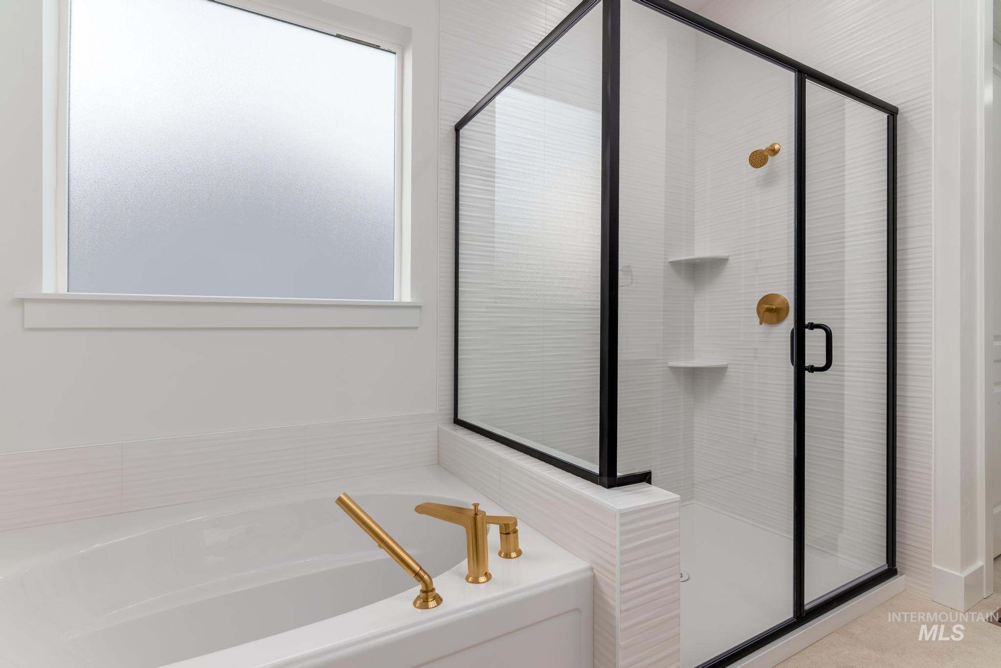 15142 Steel Cloud Avenue Caldwell, ID 83607 - Photo 21 of 34 Full bathroom with a bath, a shower stall, and plenty of natural light