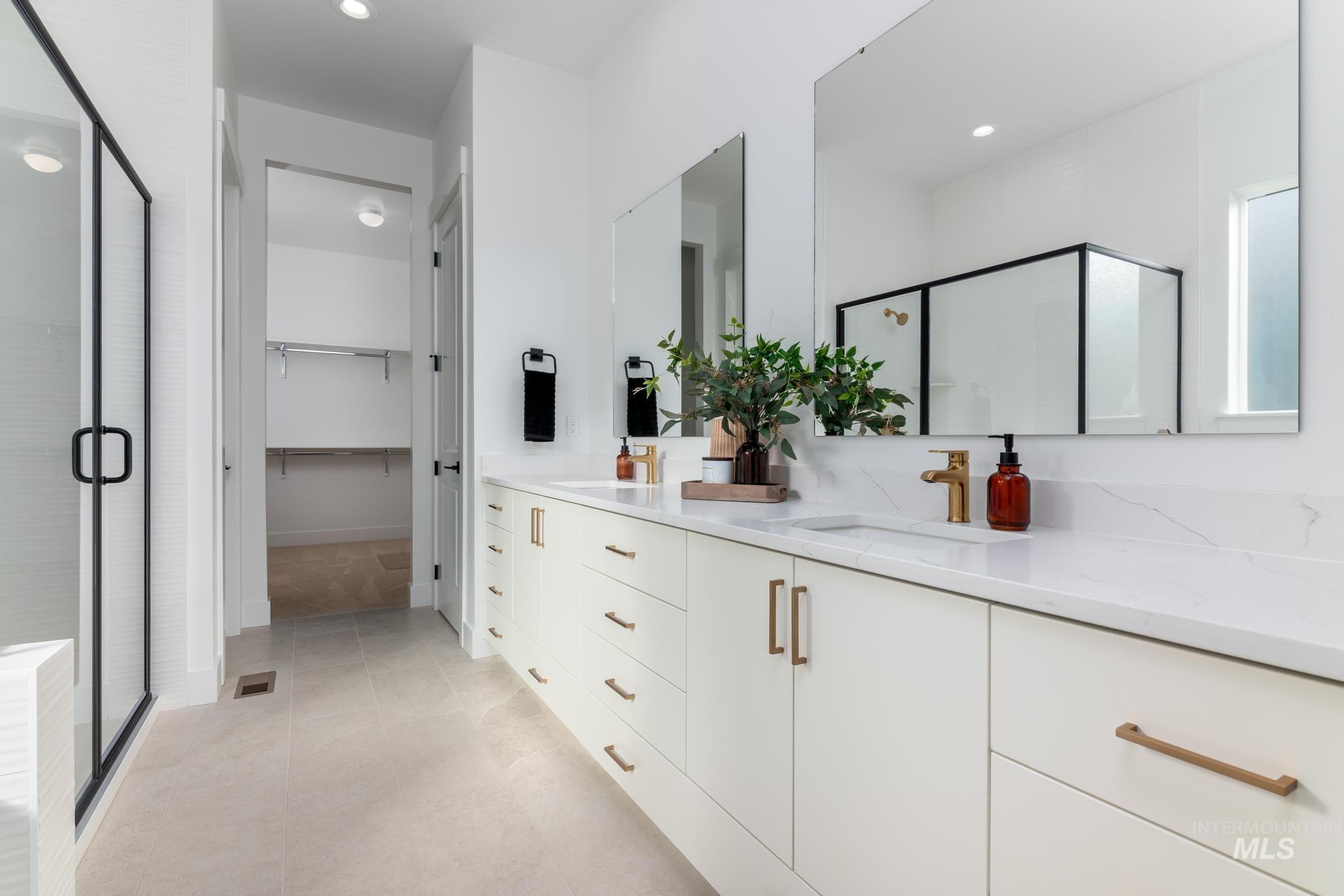 15142 Steel Cloud Avenue Caldwell, ID 83607 - Photo 22 of 44 Full bath featuring a stall shower, double vanity, a spacious closet, light tile patterned flooring, and recessed lighting