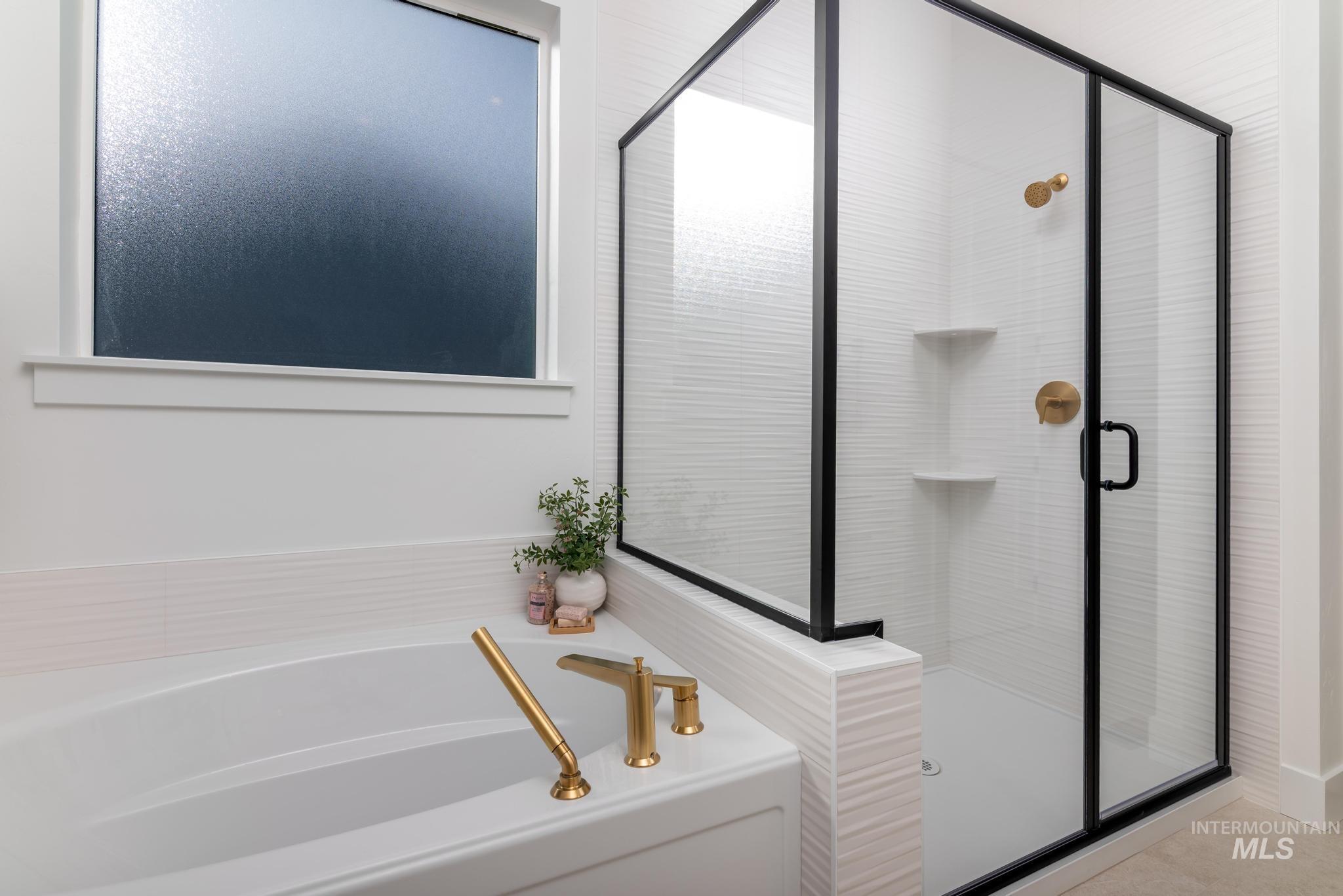 15142 Steel Cloud Avenue Caldwell, ID 83607 - Photo 23 of 44 Bathroom featuring a bath and a stall shower