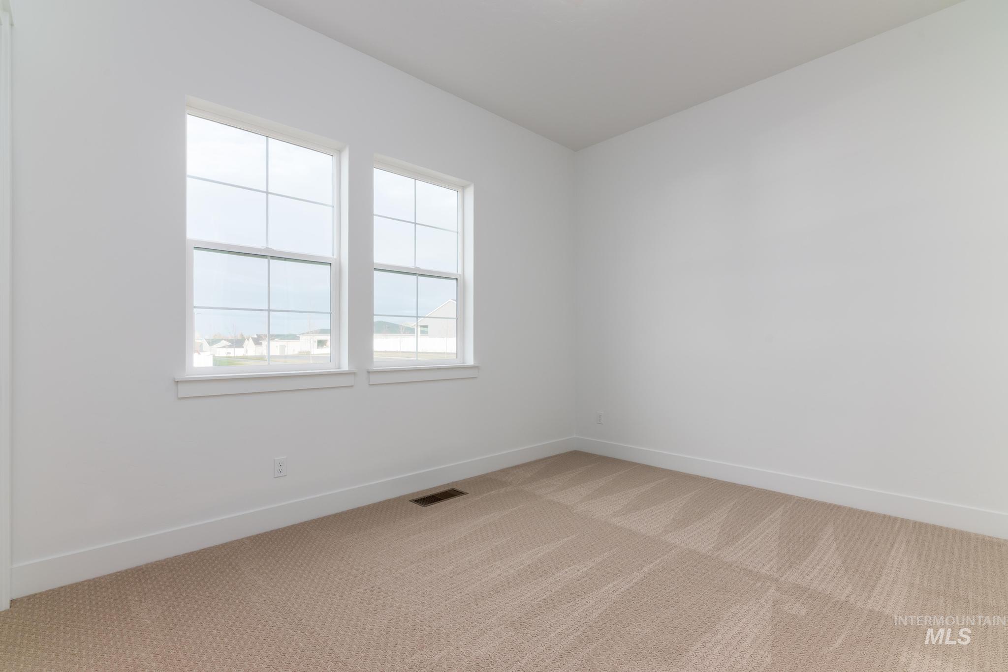15142 Steel Cloud Avenue Caldwell, ID 83607 - Photo 24 of 34 Carpeted spare room featuring baseboards