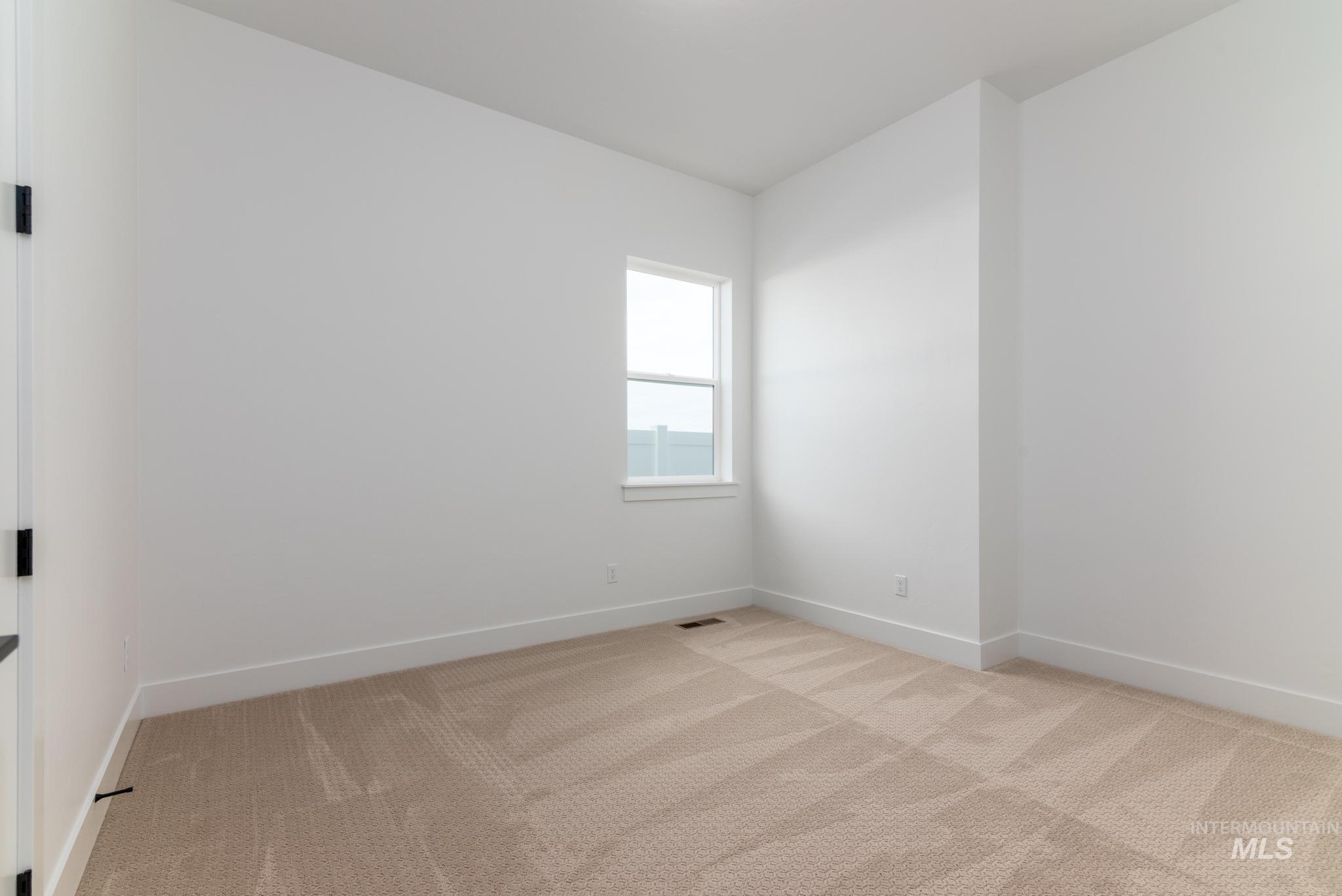 15142 Steel Cloud Avenue Caldwell, ID 83607 - Photo 25 of 34 Unfurnished room featuring baseboards and light colored carpet