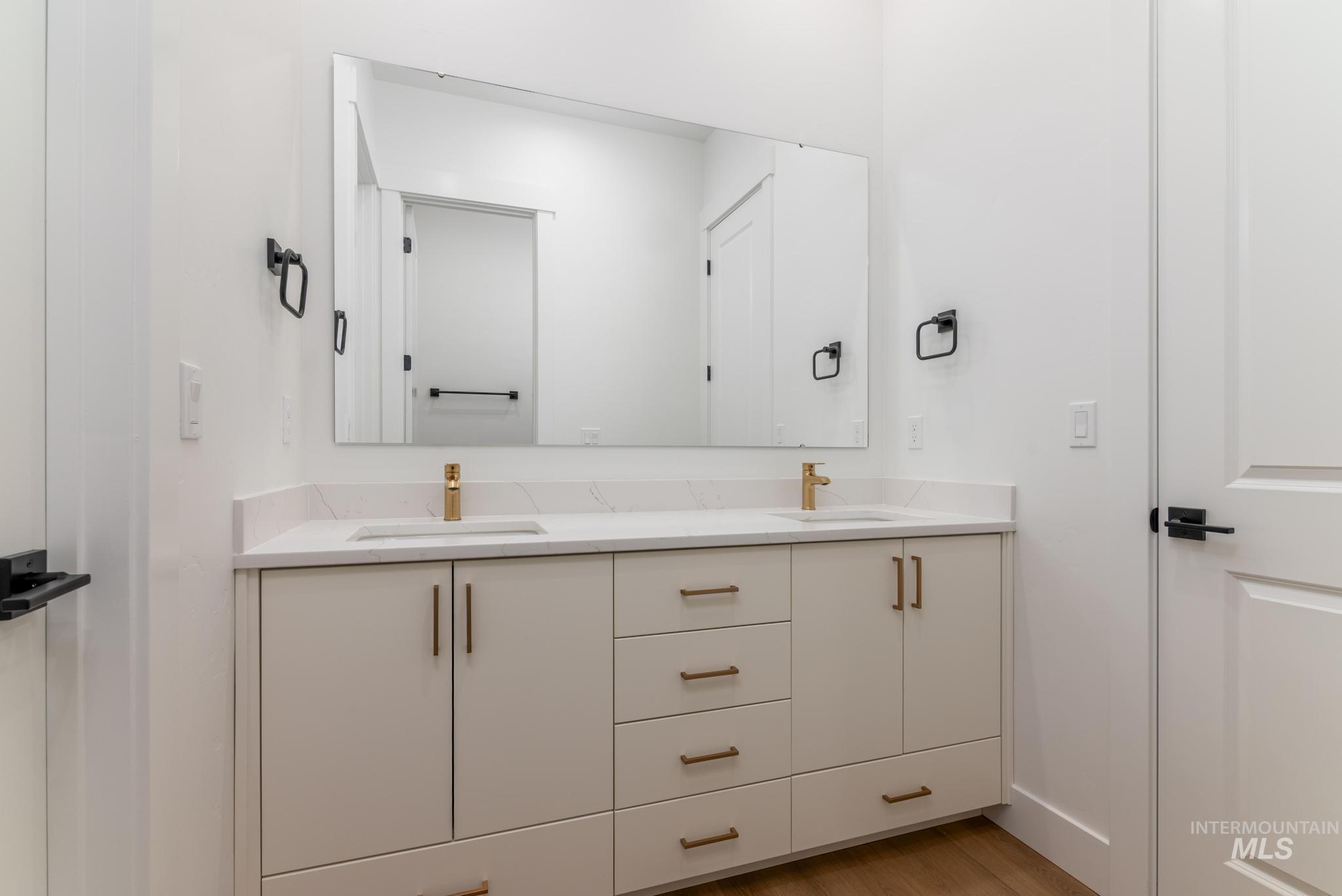 15142 Steel Cloud Avenue Caldwell, ID 83607 - Photo 26 of 34 Full bathroom featuring double vanity and light wood-style floors