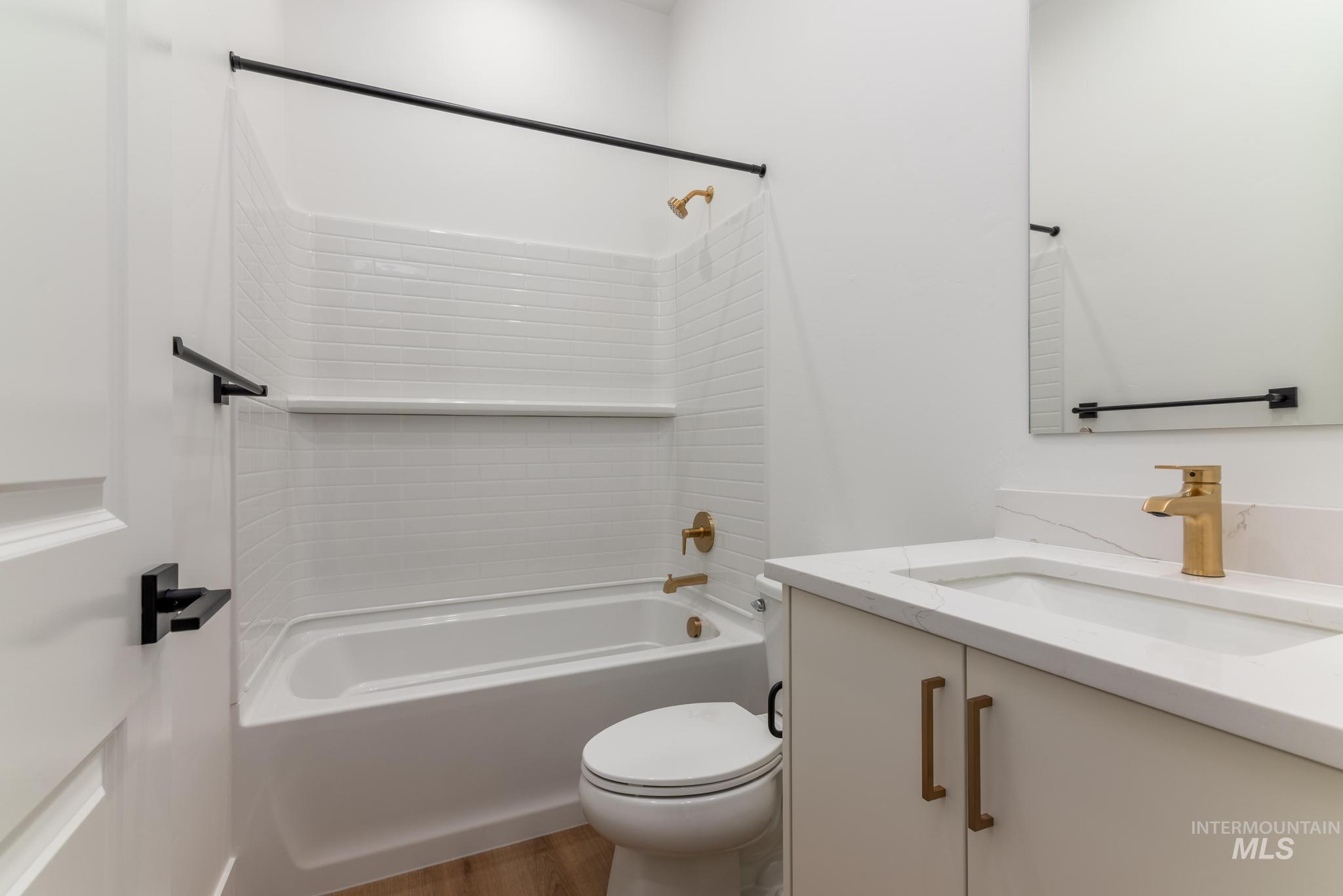 15142 Steel Cloud Avenue Caldwell, ID 83607 - Photo 27 of 34 Bathroom with tub / shower combination, vanity, and light wood-style floors
