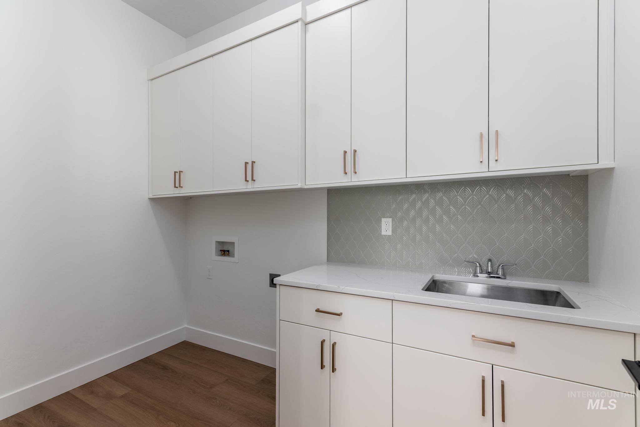 15142 Steel Cloud Avenue Caldwell, ID 83607 - Photo 28 of 34 Laundry room with dark wood-style flooring, cabinet space, and hookup for a washing machine