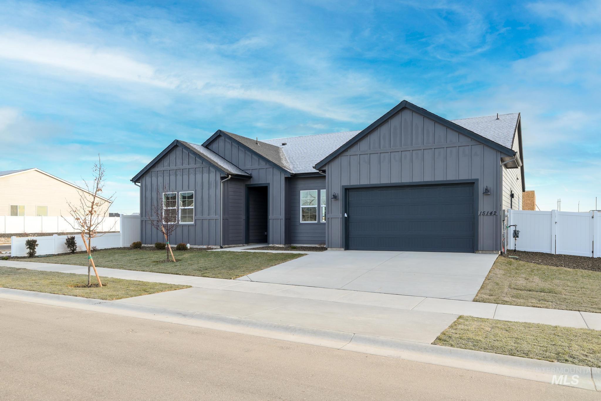 15142 Steel Cloud Avenue Caldwell, ID 83607 - Photo 3 of 34 View of front of house featuring board and batten siding, concrete driveway, a gate, a garage, and roof with shingles