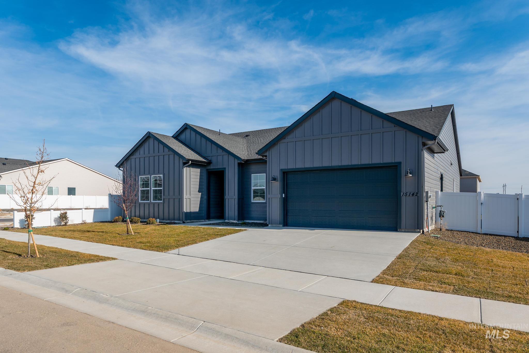 15142 Steel Cloud Avenue Caldwell, ID 83607 - Photo 3 of 44 Modern farmhouse featuring board and batten siding, a gate, driveway, a garage, and roof with shingles