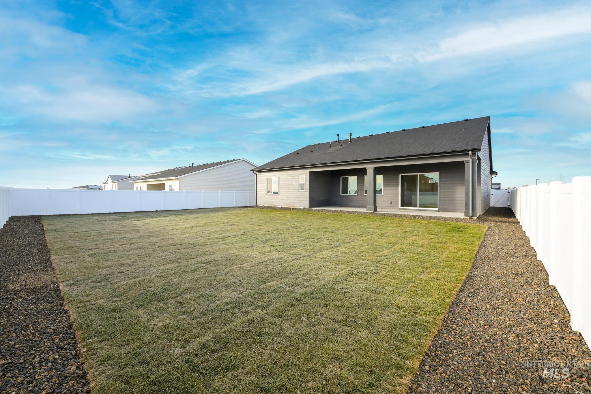 15142 Steel Cloud Avenue Caldwell, ID 83607 - Photo 33 of 44 Rear view of house with a fenced backyard and a patio area