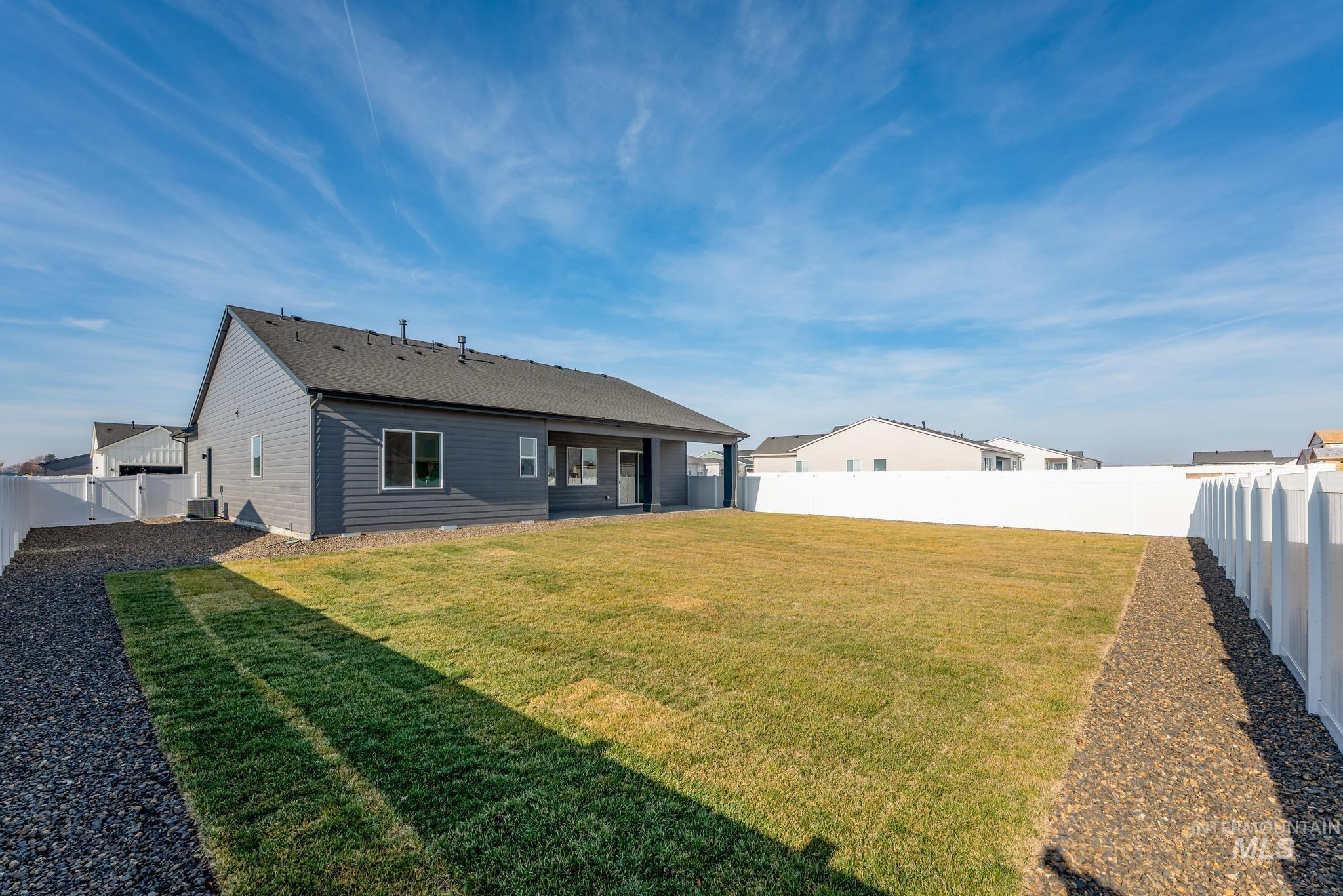 15142 Steel Cloud Avenue Caldwell, ID 83607 - Photo 34 of 44 Rear view of property with a patio, a fenced backyard, and a gate