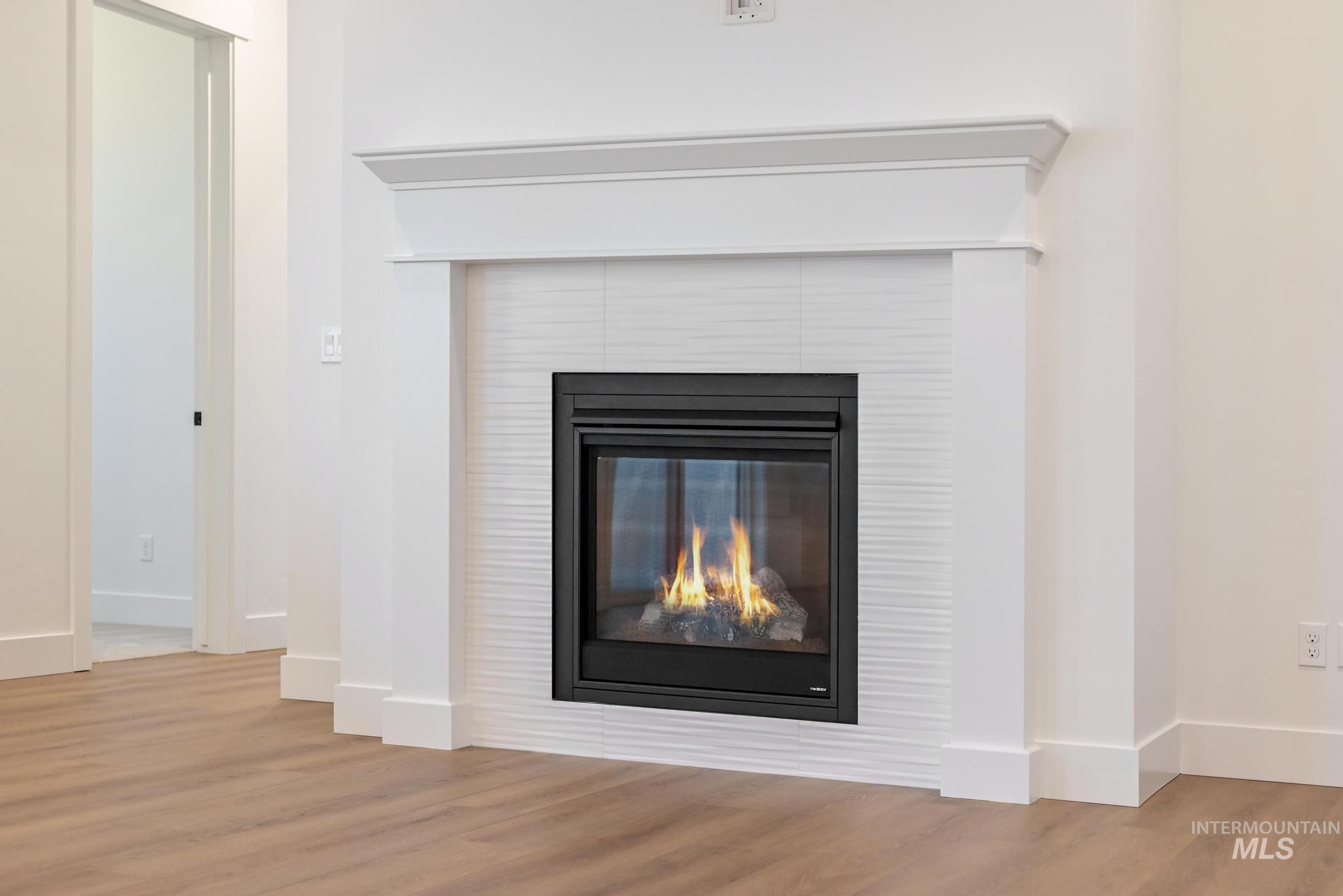 15142 Steel Cloud Avenue Caldwell, ID 83607 - Photo 5 of 34 Detailed view of wood finished floors and a tile fireplace