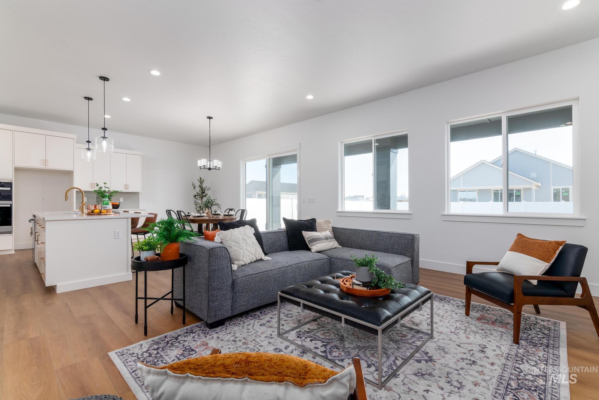 15142 Steel Cloud Avenue Caldwell, ID 83607 - Photo 7 of 44 Living area featuring light wood-style floors and hanging lights
