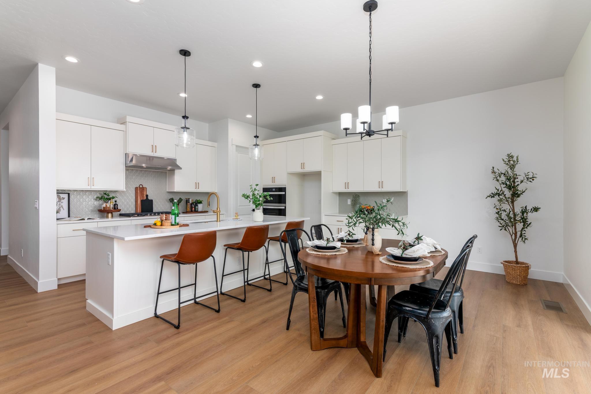 15142 Steel Cloud Avenue Caldwell, ID 83607 - Photo 8 of 44 Dining space featuring light wood-type flooring and a chandelier