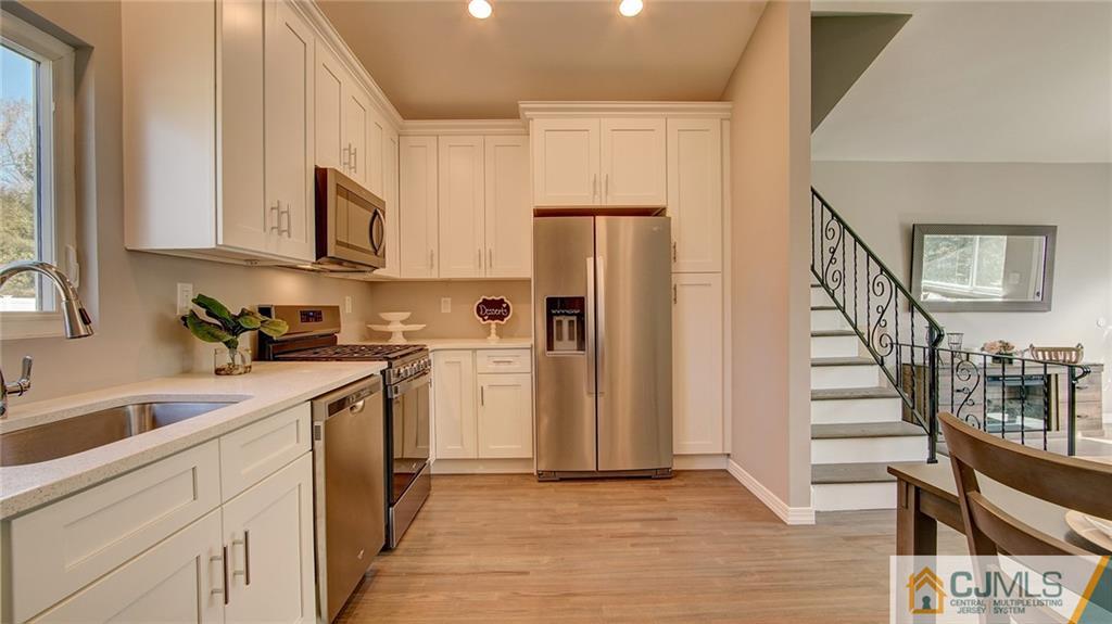 45 Middlesex Road Old Bridge, NJ 07747 - Photo 12 of 35 a kitchen with a sink a refrigerator and cabinets