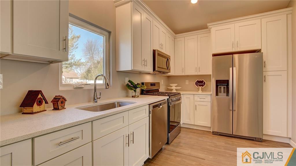 45 Middlesex Road Old Bridge, NJ 07747 - Photo 13 of 35 a kitchen with white cabinets and refrigerator