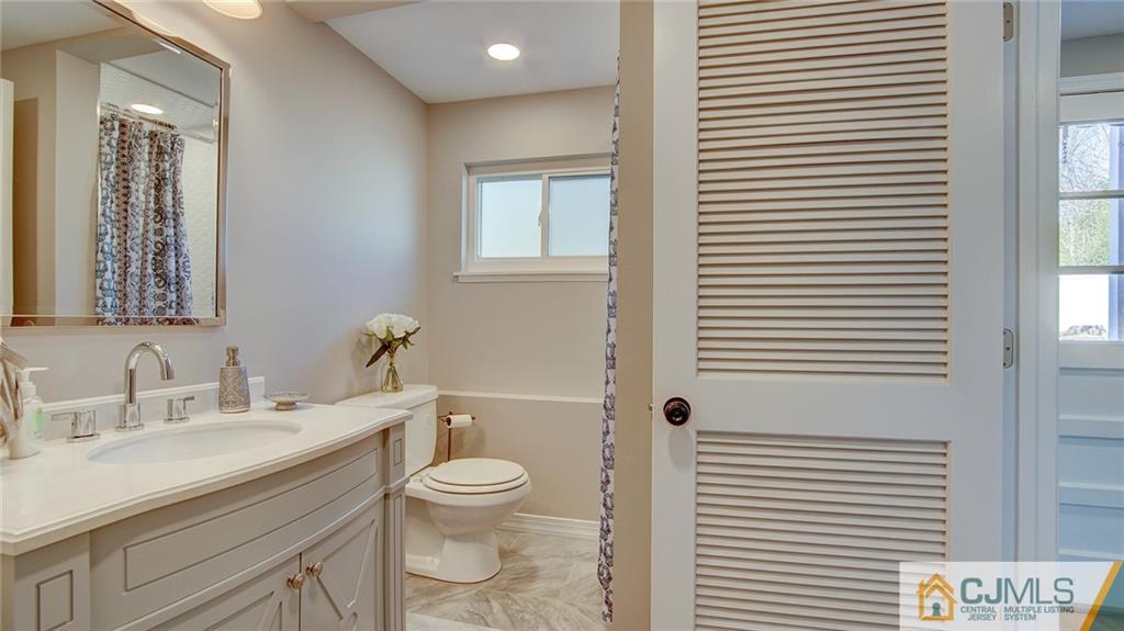 45 Middlesex Road Old Bridge, NJ 07747 - Photo 18 of 35 a bathroom with a toilet a sink and a large mirror