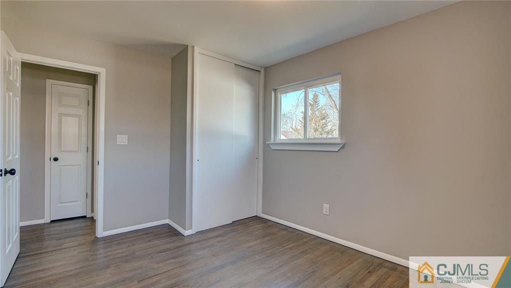 45 Middlesex Road Old Bridge, NJ 07747 - Photo 24 of 35 an empty room with wooden floor and windows