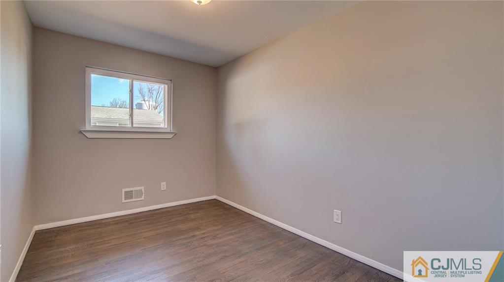 45 Middlesex Road Old Bridge, NJ 07747 - Photo 25 of 35 wooden floor in an empty room with a window
