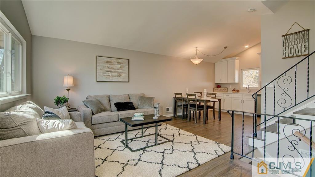 45 Middlesex Road Old Bridge, NJ 07747 - Photo 4 of 35 a living room with furniture and a dining table with wooden floor