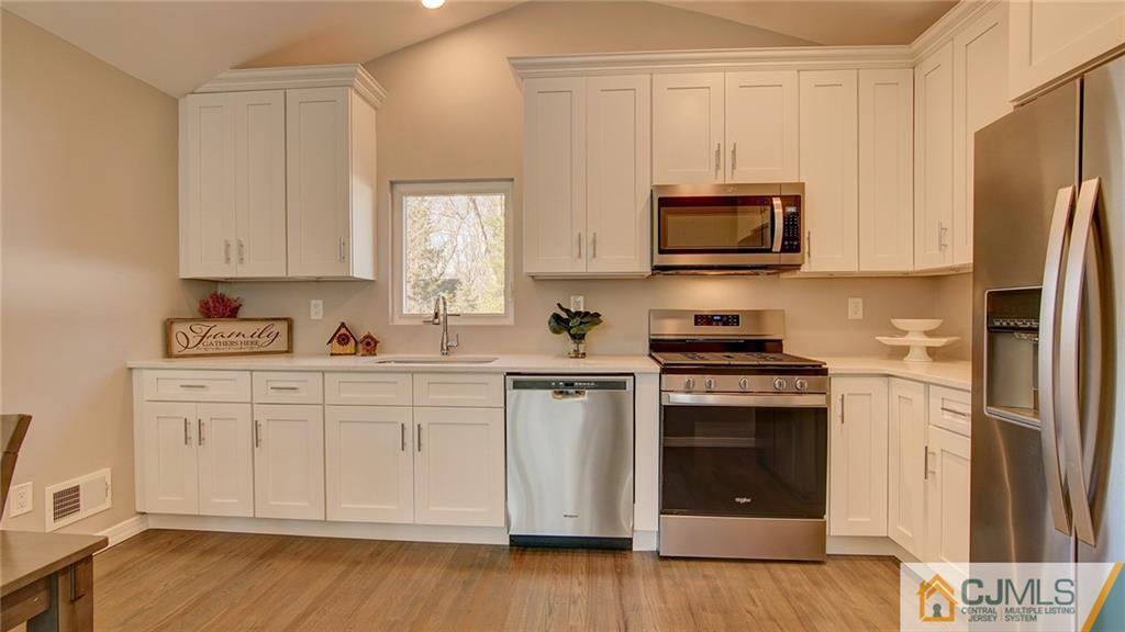 45 Middlesex Road Old Bridge, NJ 07747 - Photo 8 of 35 a kitchen with stainless steel appliances granite countertop a stove a sink and a refrigerator