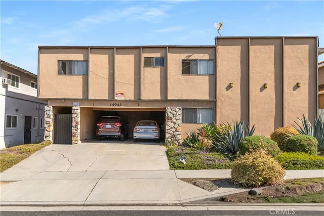 a view of a brick house with potted plants