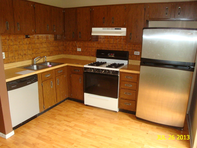 250 Rodenburg Road Roselle, IL 60172 - Photo 4 of 13 a kitchen with stainless steel appliances granite countertop a refrigerator a sink and white cabinets