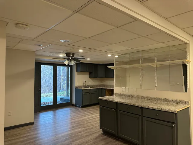 a kitchen with granite countertop stainless steel appliances and wooden cabinets