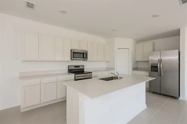 a kitchen that has a sink and a stove