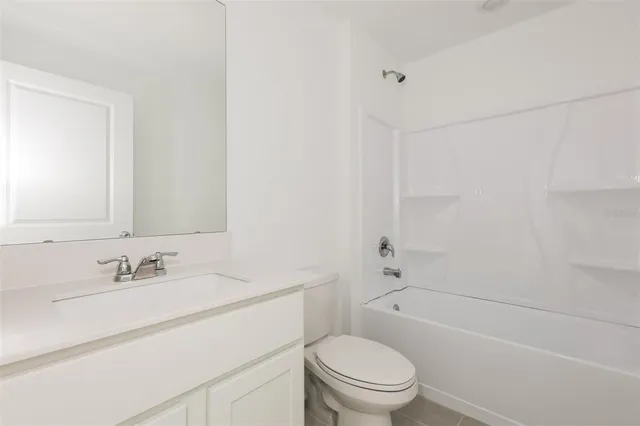 a bathroom with a sink toilet vanity and shower