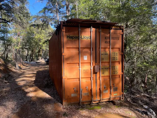 a view of a small barn with a door