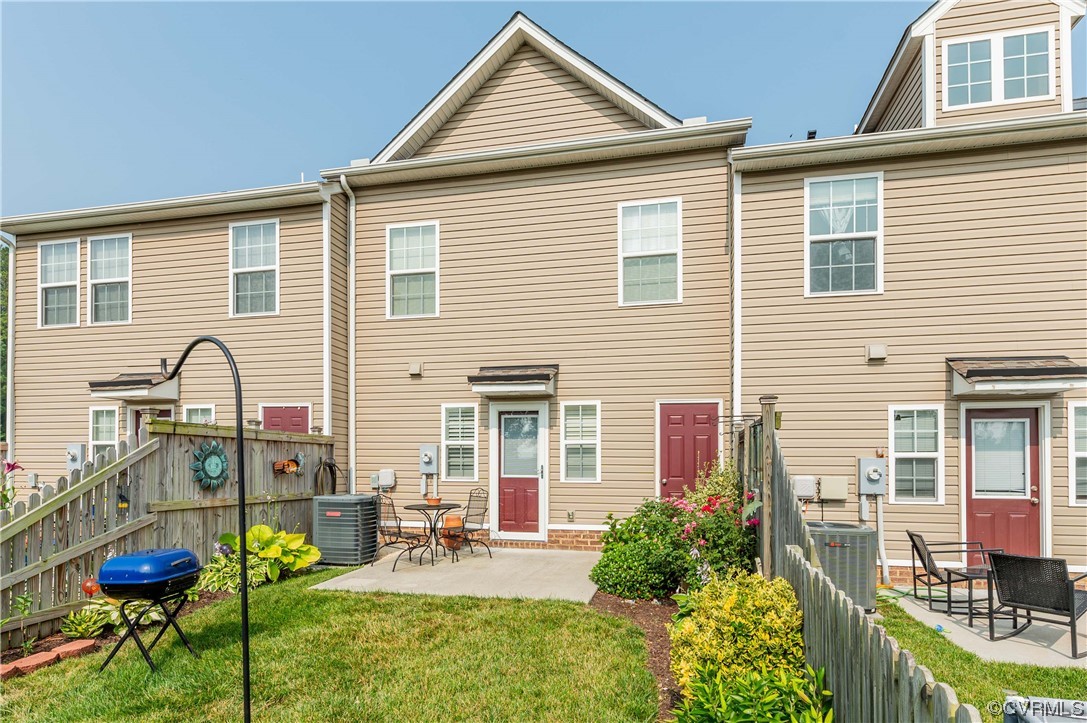 1314 Stone Rdg Pk Loop Henrico, VA 23228 - Photo 17 of 20 Back of house with a lawn and central AC