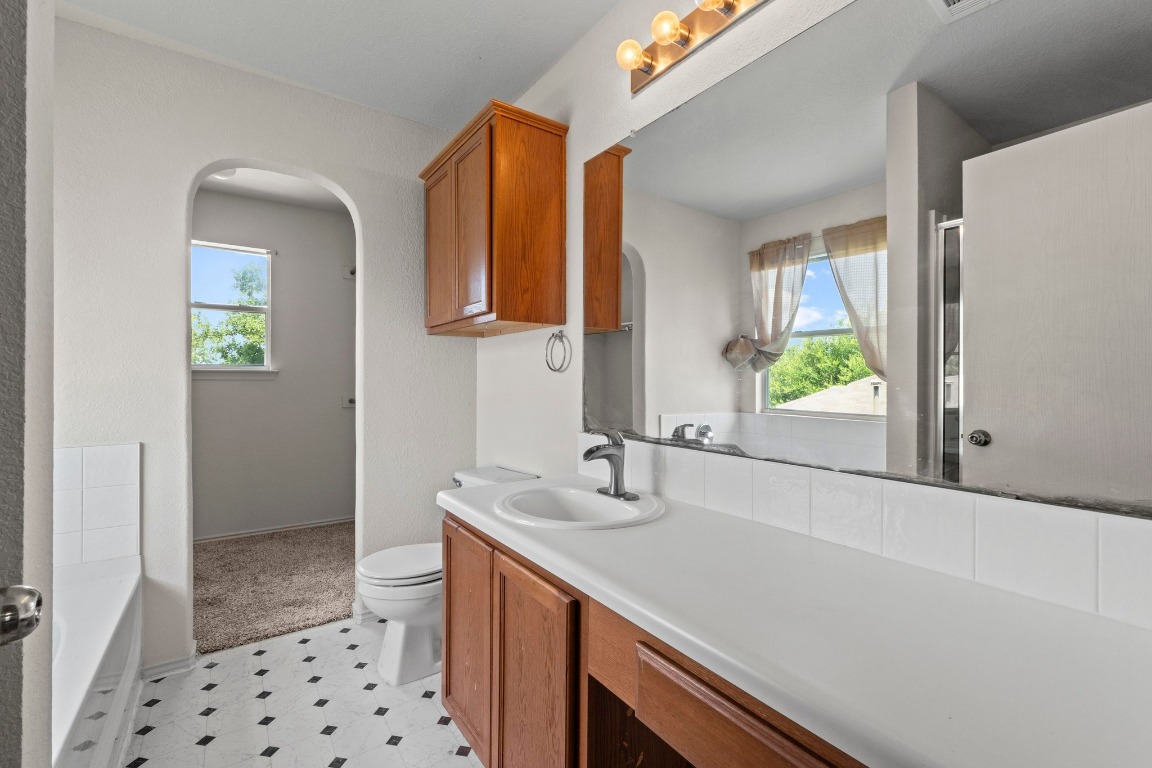 4608 Acers Lane Austin, TX 78725 - Photo 17 of 27 The en-suite bathroom contains a long vanity and lots of cabinet space for linens and/or bathroom needs.