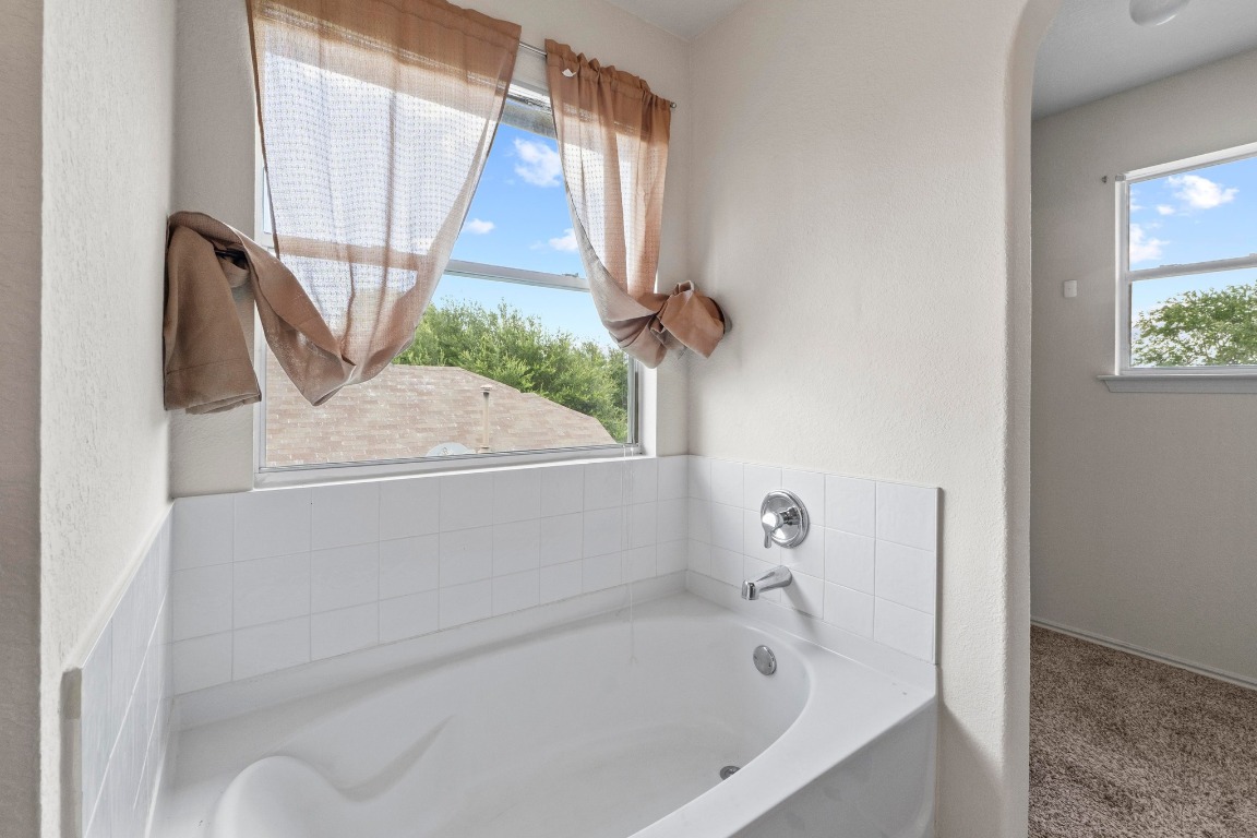 4608 Acers Lane Austin, TX 78725 - Photo 19 of 27 The soaking tub is sun-lit and is the perfect place to relax after a busy day.