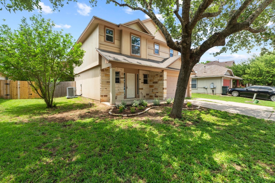 4608 Acers Lane Austin, TX 78725 - Photo 2 of 27 The front yard is shaded by tall trees and the lovely exterior invites you to the front door.