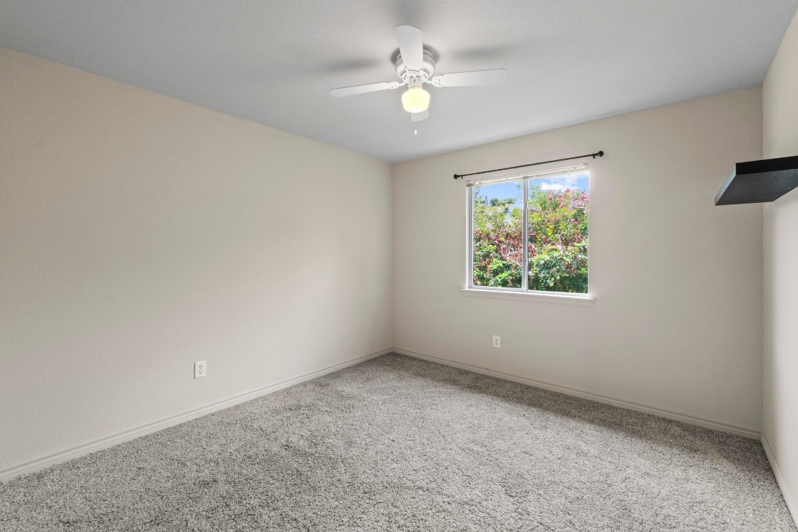 4608 Acers Lane Austin, TX 78725 - Photo 21 of 27 High ceilings, a ceiling fan, and a walk-in closet in this bedroom.