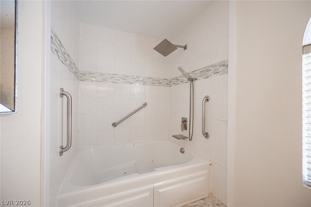 718 Rusty Spur Drive Henderson, NV 89014 - Photo 49 of 50 Indulge in a jetted tub and modern shower, creating a serene personal retreat.
