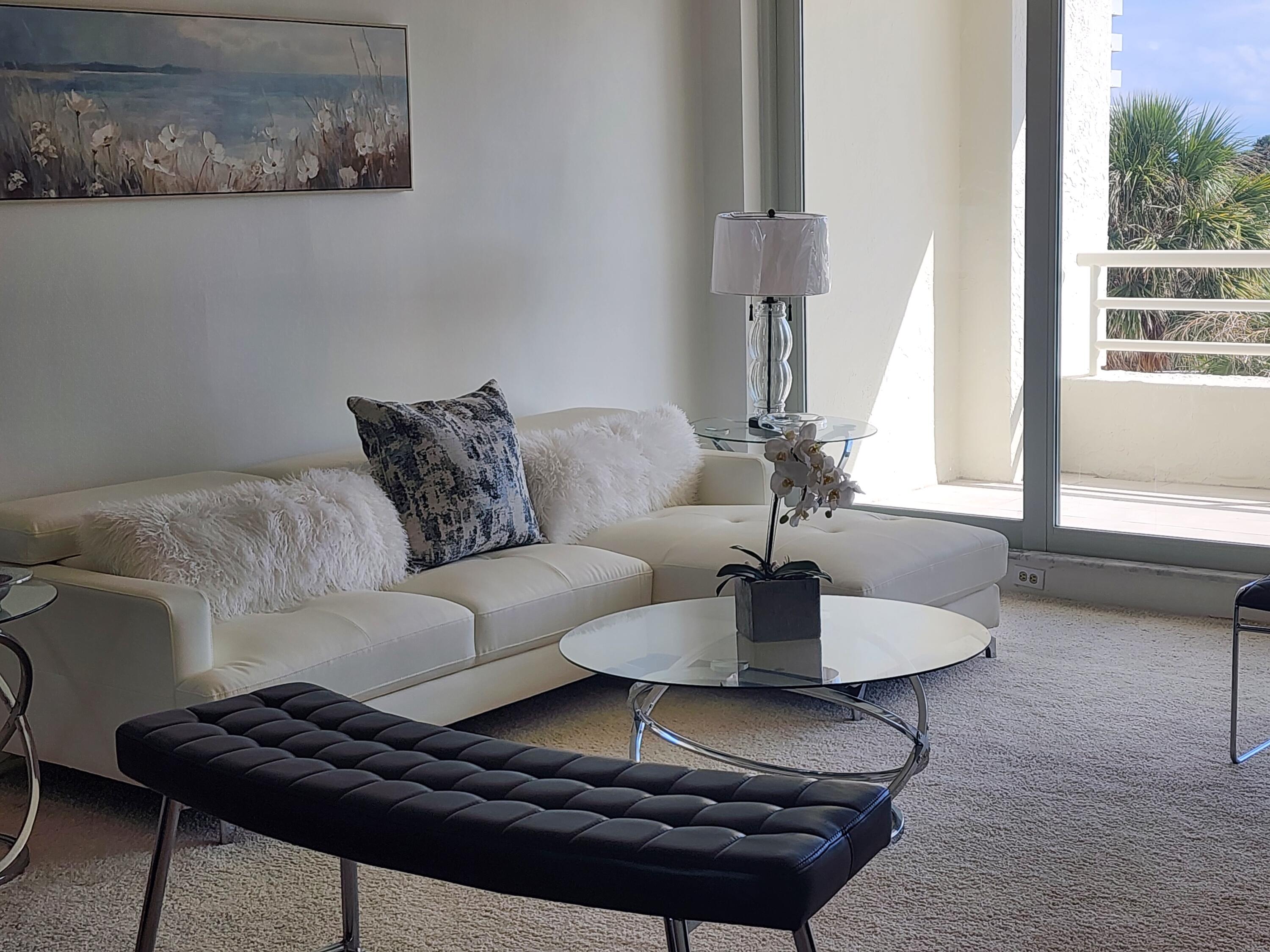 4201 North Ocean Boulevard, Unit 307 Boca Raton, FL 33431 - Photo 22 of 38 a living room with furniture and a rug