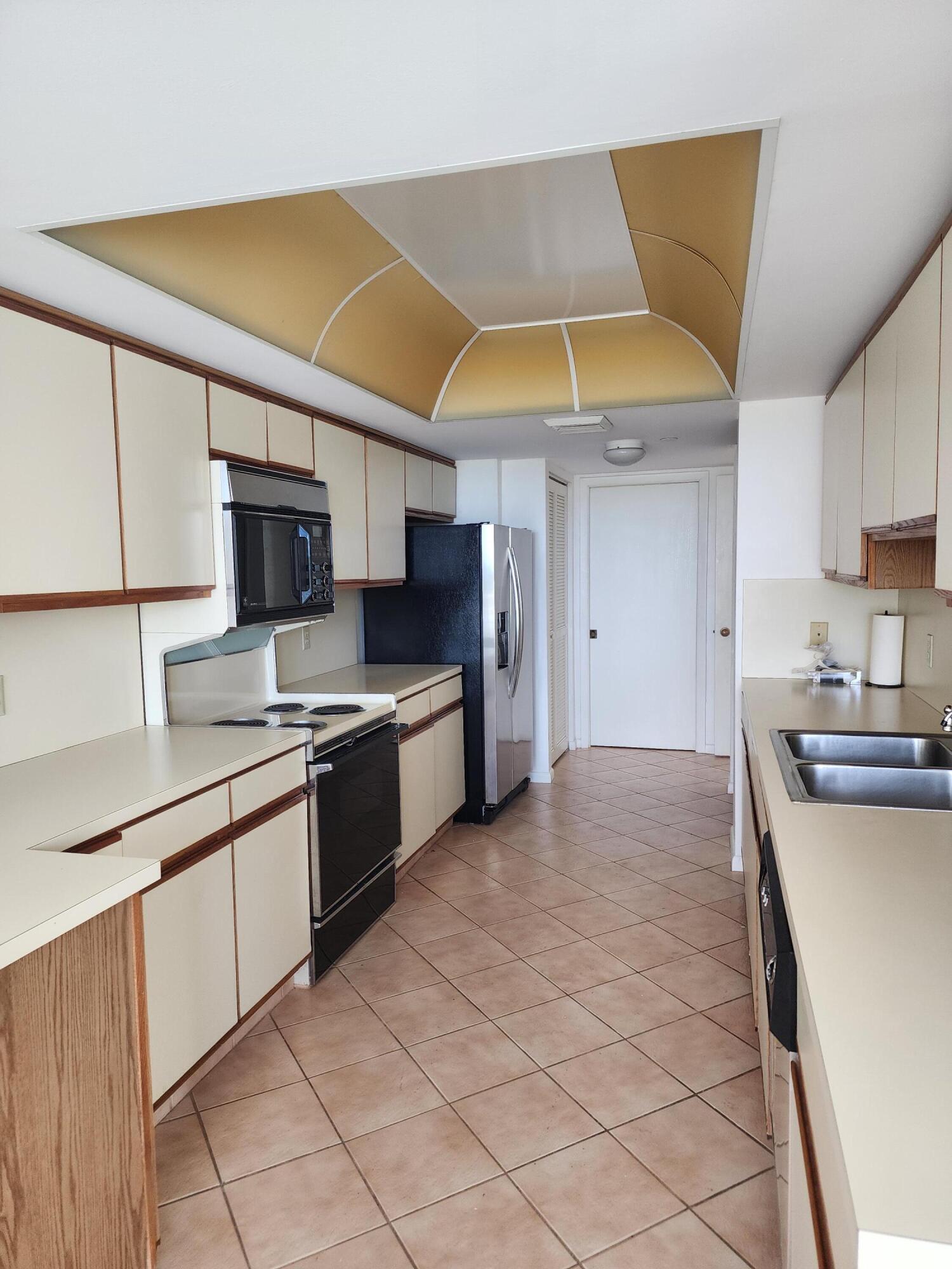 4201 North Ocean Boulevard, Unit 307 Boca Raton, FL 33431 - Photo 25 of 38 a kitchen with stainless steel appliances granite countertop a sink and a stove