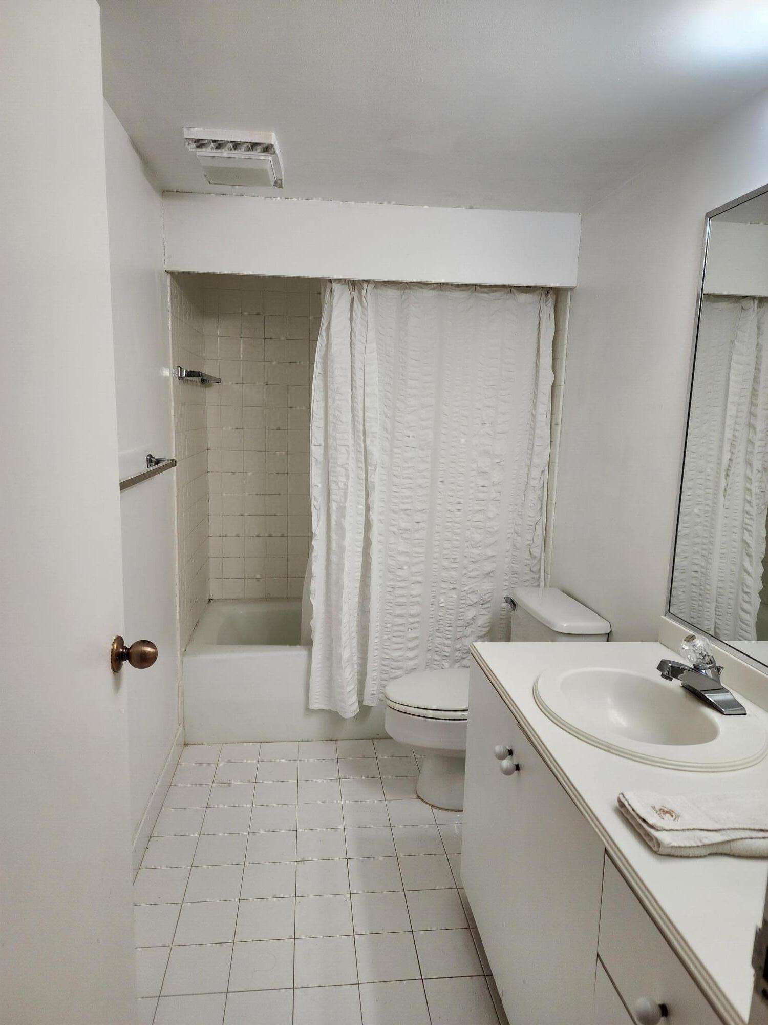4201 North Ocean Boulevard, Unit 307 Boca Raton, FL 33431 - Photo 27 of 38 a bathroom with a sink a toilet and shower