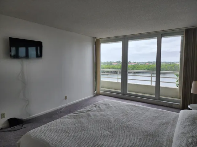 a bedroom with a bed a table and a window