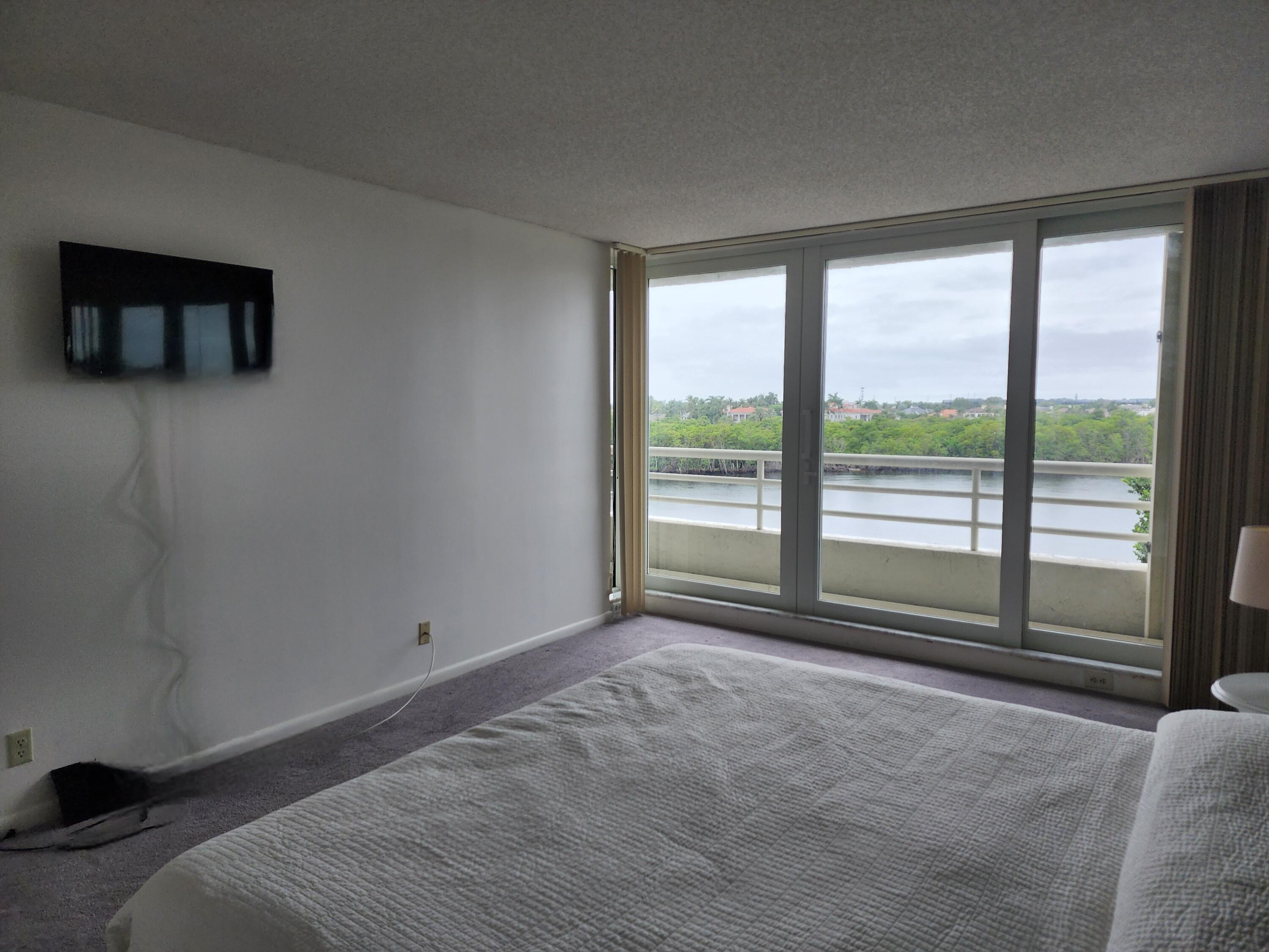 4201 North Ocean Boulevard, Unit 307 Boca Raton, FL 33431 - Photo 28 of 38 a view of room with window and a ceiling fan
