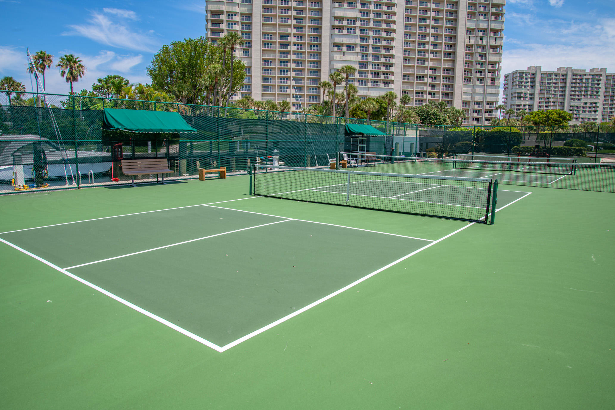 4201 North Ocean Boulevard, Unit 307 Boca Raton, FL 33431 - Photo 9 of 38 a view of a tennis ground with large trees