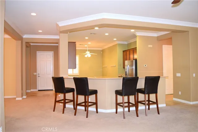 a view of a dining room with furniture and a potted plant