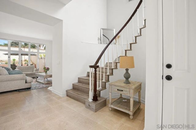 a view of a hallway view with wooden floor and staircase