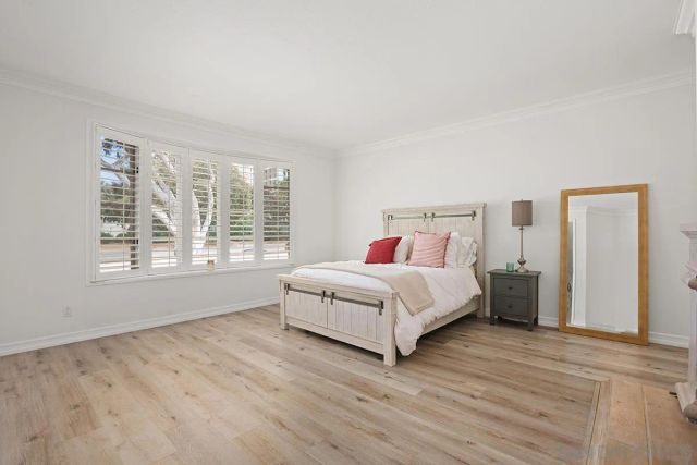 a bedroom with a large bed and a large window