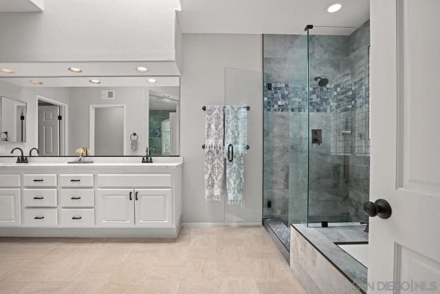 a bathroom with a granite countertop sink mirror and double