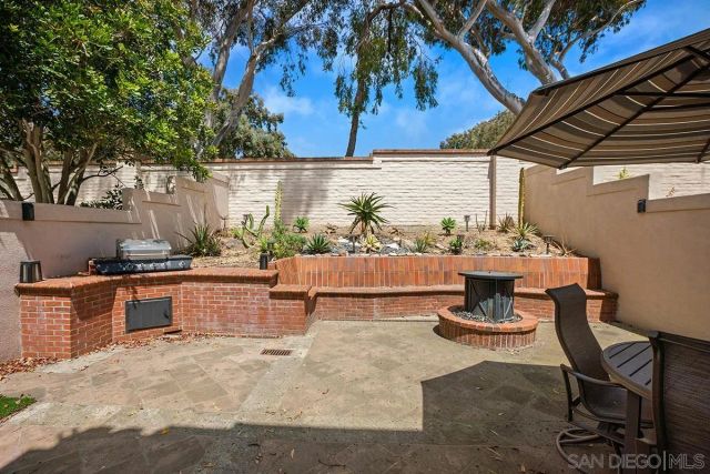 a view of a chairs and table in patio