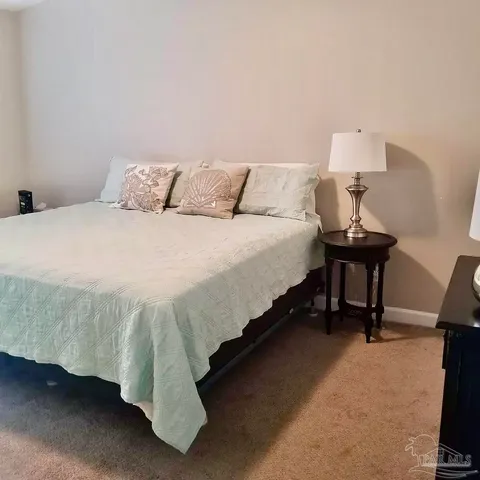 a bedroom with a bed and a night stand