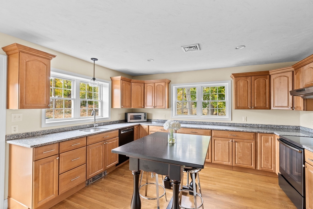 8 Hayes Road Hingham, MA 02043 - Photo 2 of 25 a kitchen with a table chairs sink and cabinets